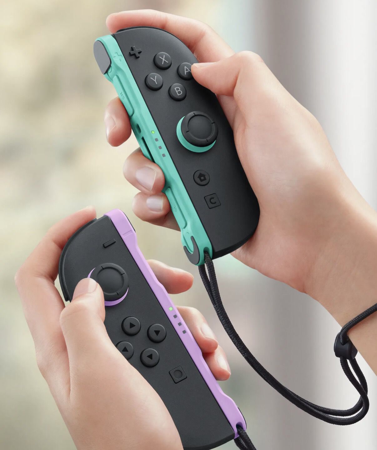 Joy-Con 2 controllers in hand